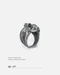 A 45-degree view of oxidized 925 silver octopus ring with black zircon eyes on white background, by Dzoo, at Rainbow Tears.
