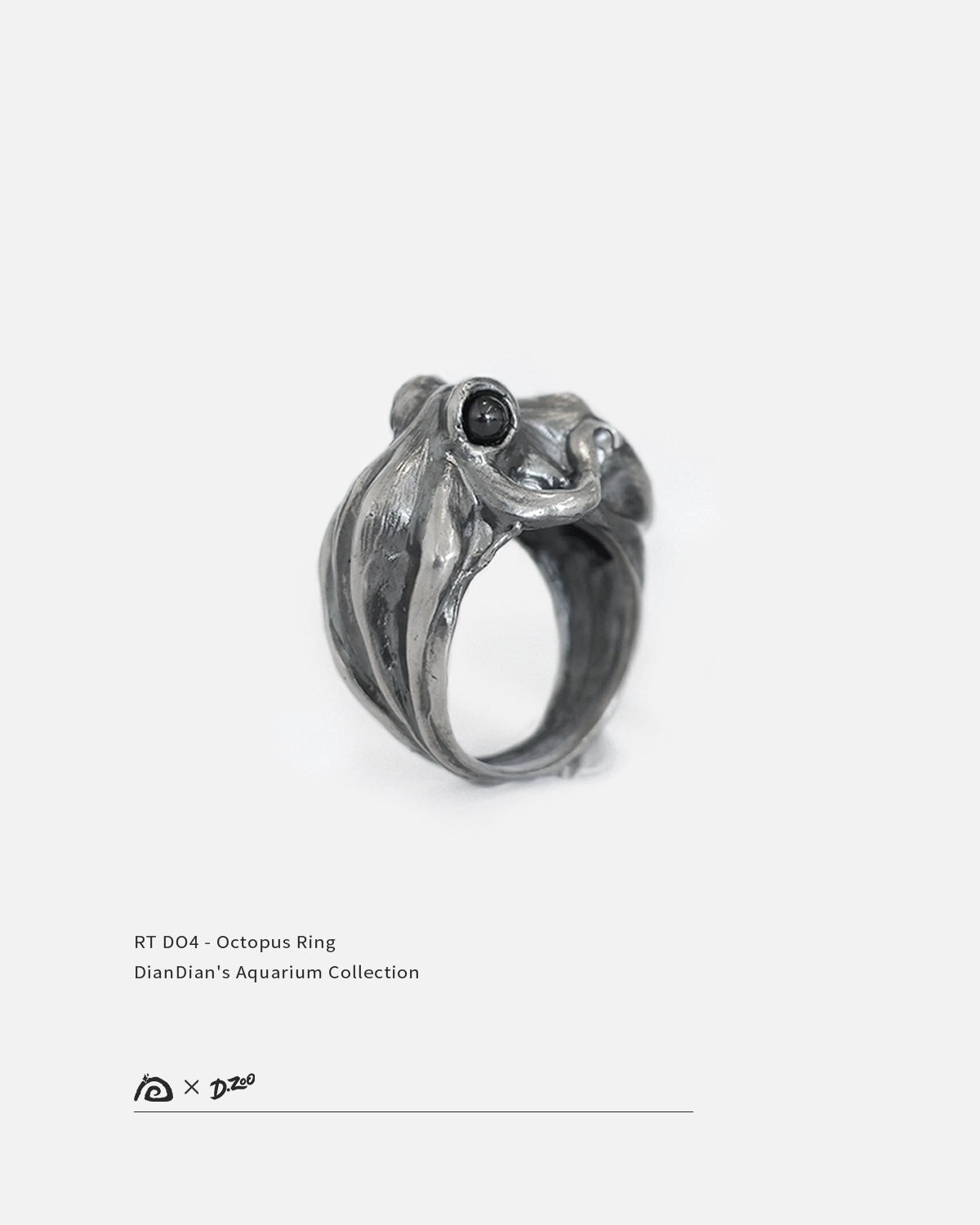 A 45-degree view of oxidized 925 silver octopus ring with black zircon eyes on white background, by Dzoo, at Rainbow Tears.