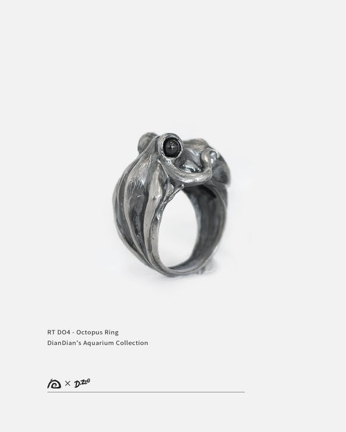 A 45-degree view of oxidized 925 silver octopus ring with black zircon eyes on white background, by Dzoo, at Rainbow Tears.