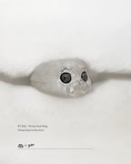 A 45-degree view of the 925 sterling silver Ploop seal ring on a white blanket, by Dzoo, available at Rainbow Tears.
