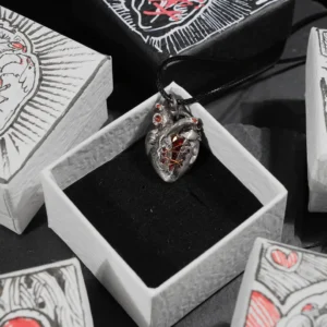 A Rebel Heart pendant displayed inside a hand-drawn heart jewelry box.
