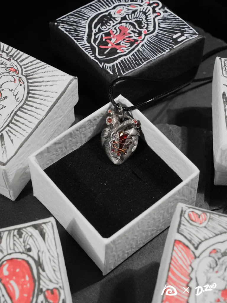 A Rebel Heart pendant displayed inside a hand-drawn heart jewelry box.