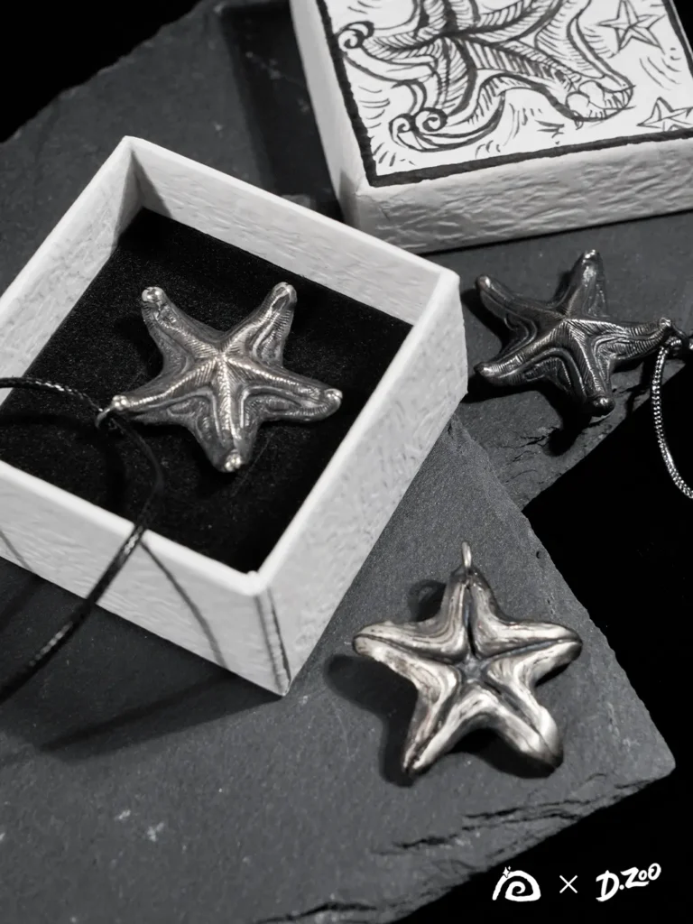 Three oxidized silver starfish pendants displayed with a hand-drawn starfish jewelry box, showcasing the vintage starfish necklace design.