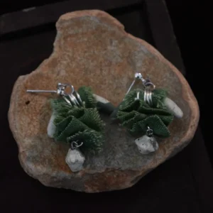 Handmade blue-and-white porcelain earrings, longhorn-shaped, with green plant-dyed fabric and irregular octahedron porcelain accents