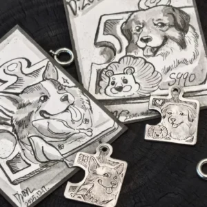 Two handcrafted dog puzzle piece necklace pendants shown with hand-drawn cards with pictures of dogs on them