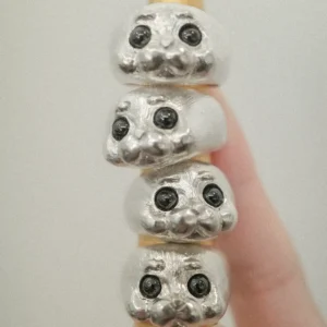 Four seal rings stacked on a ring mandrel showing their playful design