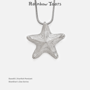 Front view of a bright handcrafted silver starfish pendant on a white background