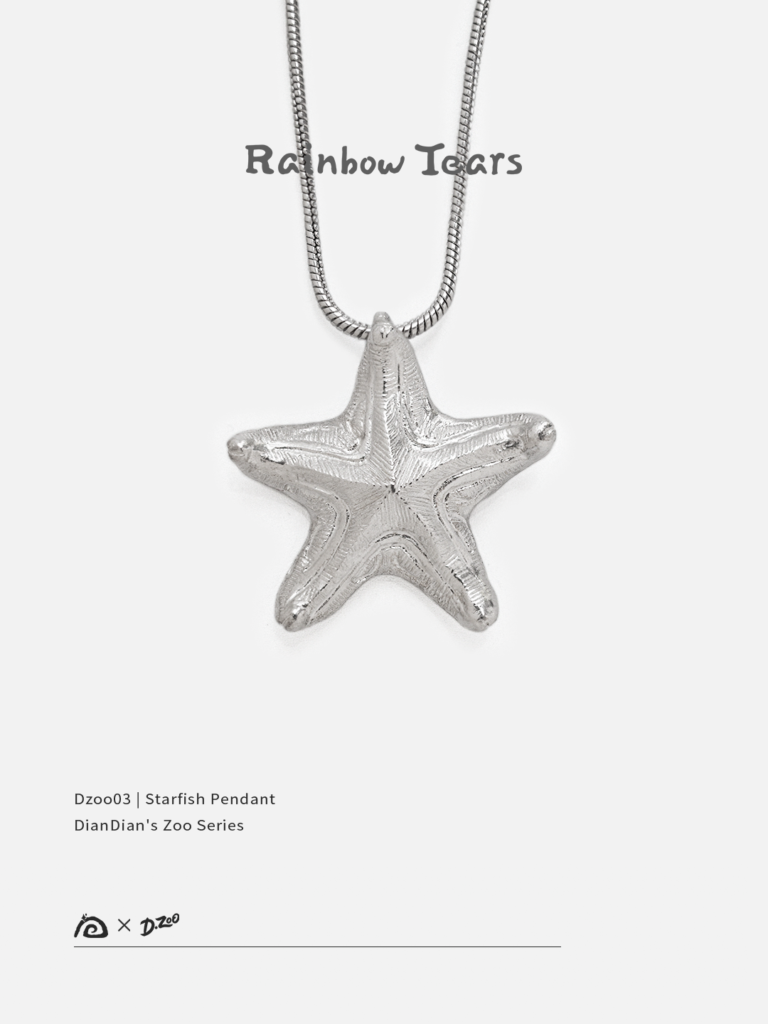 Front view of a bright handcrafted silver starfish pendant on a white background
