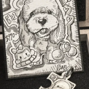 Custom puzzle piece necklace featuring a cute dog pendant beside a hand-drawn designer illustration card