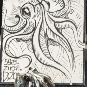 Octopus ring displayed with a designer’s hand-drawn illustration card on the product page