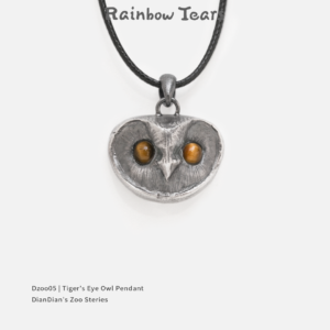 Front view of a sterling silver owl pendant with tiger's eye stone eyes on a white background