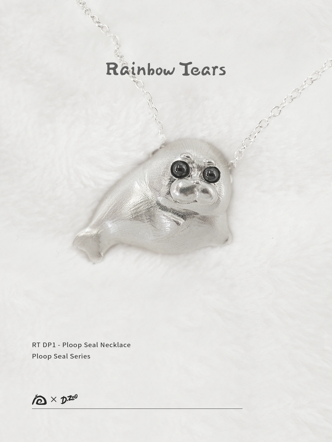 Front view of the Ploop seal necklace on white velvet