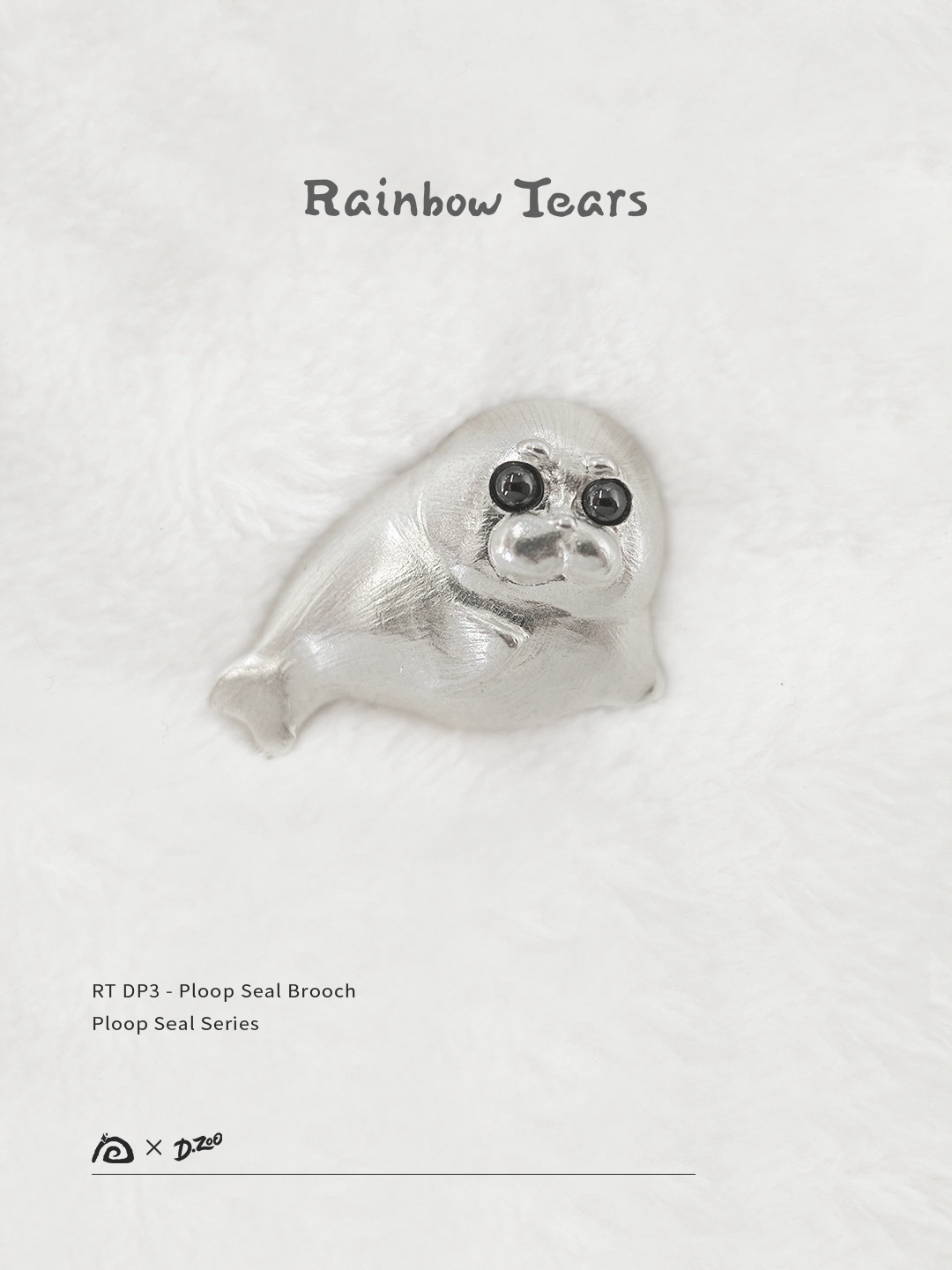 Front view of the pure silver Ploop seal brooch placed on white velvet