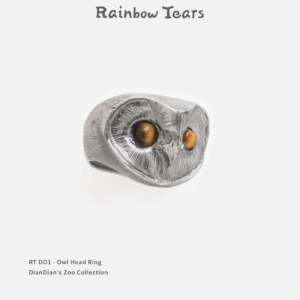 Hand-sculpted sterling silver owl head ring featuring two natural tiger eye stones as glowing eyes.