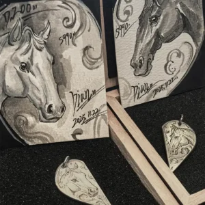 A pair of 990 fine silver half heart pendants with horse patterns, displayed alongside two exquisitely hand-painted horse art cards.