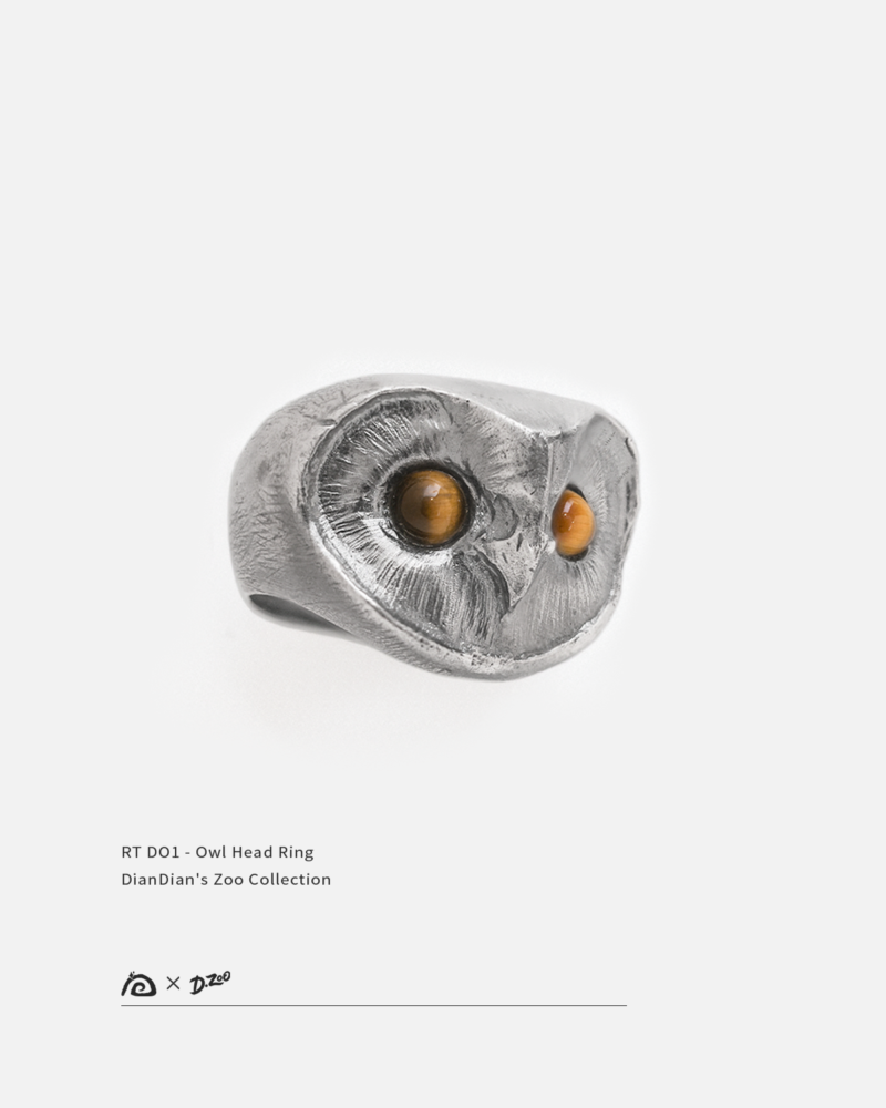 Hand-sculpted sterling silver owl head ring featuring two natural tiger eye stones as glowing eyes.