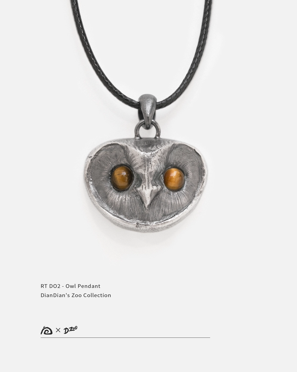 Front view of a sterling silver owl pendant with tiger's eye stone eyes on a white background