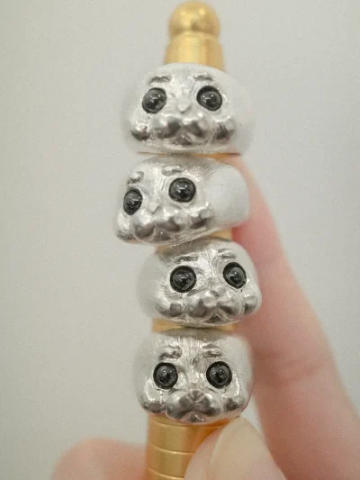 Four seal rings stacked on a ring mandrel showing their playful design